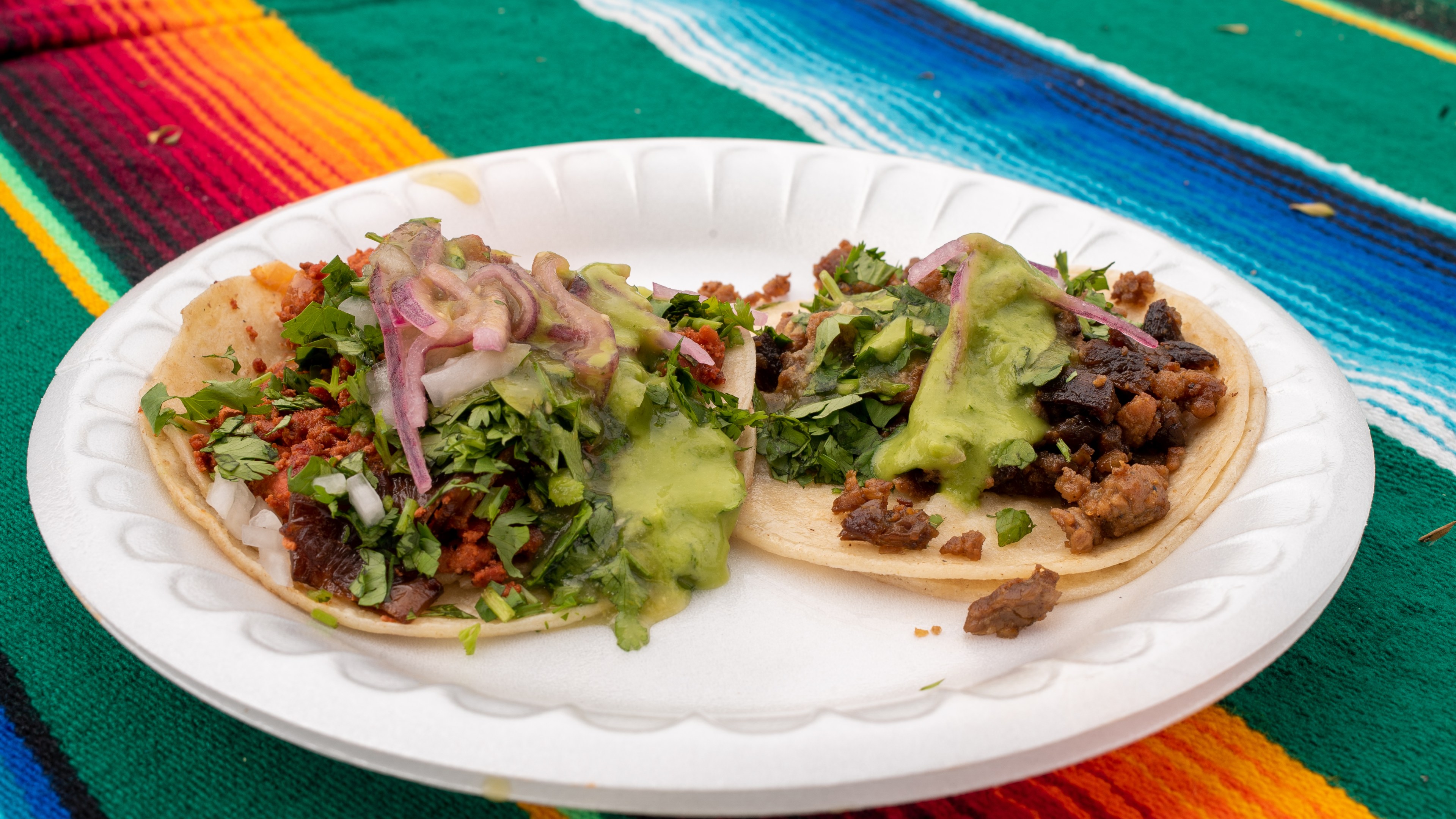 A taco de asada and a taco de chicharrón at Tacos de Canasta