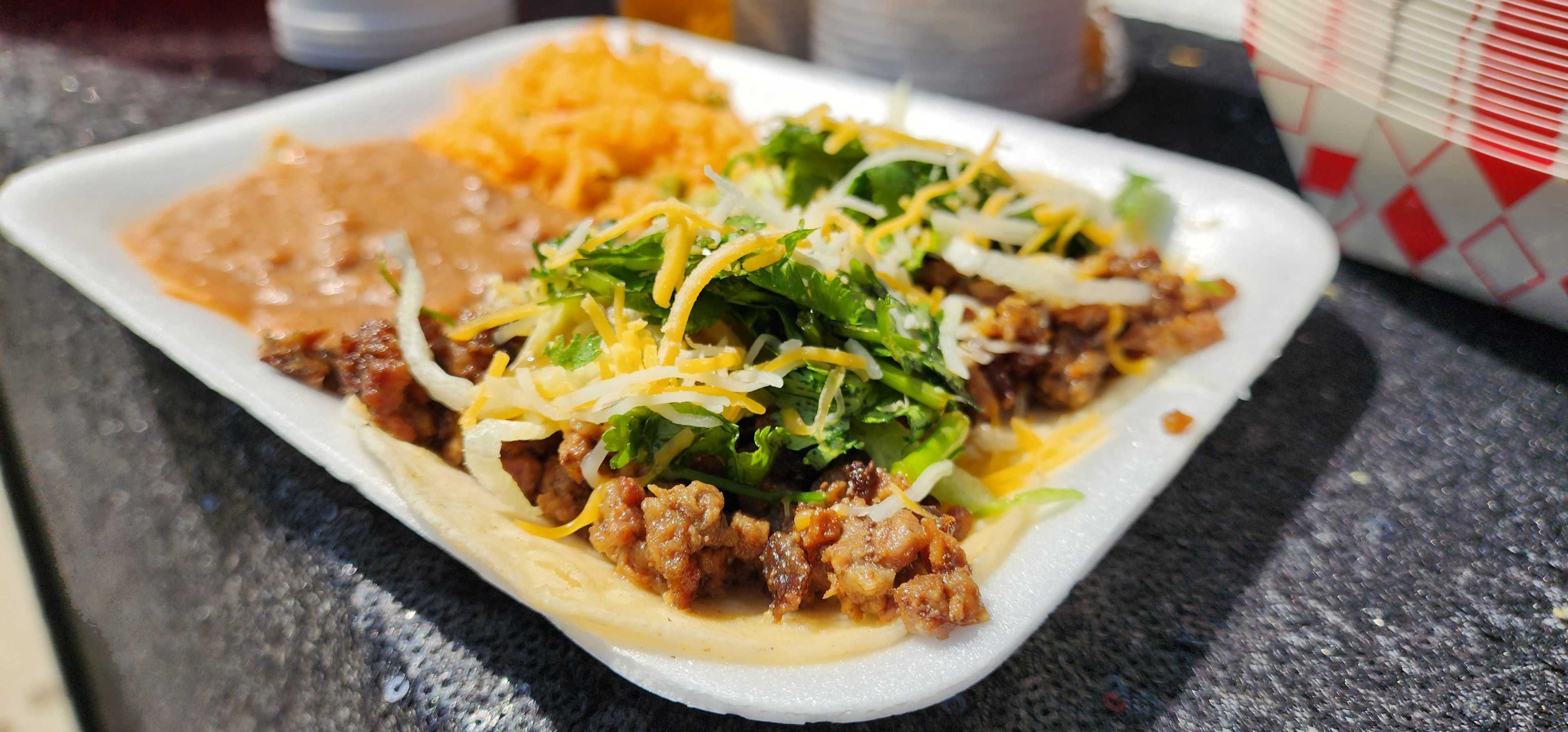 A plate of tacos, beans and rice from D's Tipsy Tacos